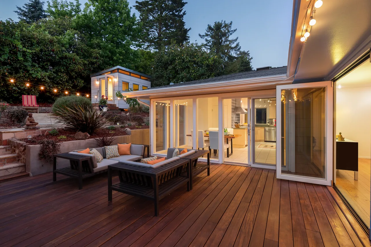Home with an open wood patio deck at dusk